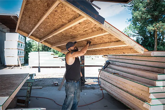 man carrying wall panel